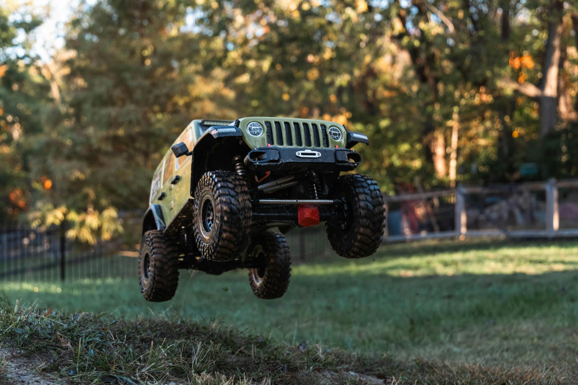 toy jeep off road jump in autumn backyard